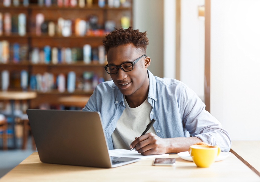 Man studying at a laptop in a library